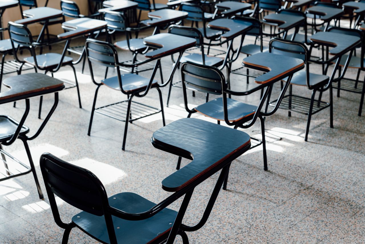 Offerings Rows of empty desks in a bright Buenos Aires classroom, symbolizing education and learning environment.